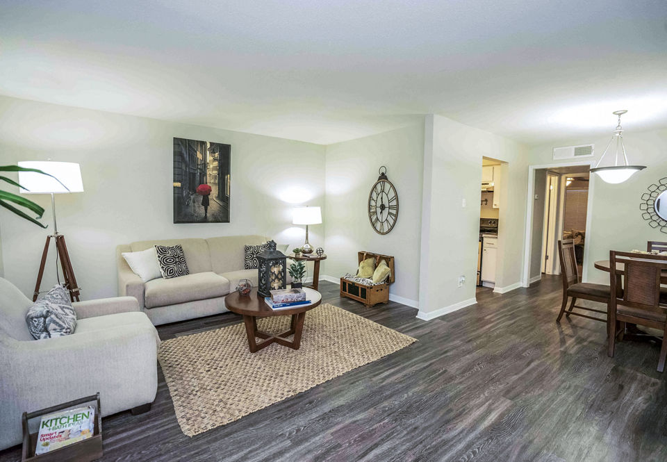 Spacious living room with modern furnishings at 3 Corners West Apartments in Greystar community