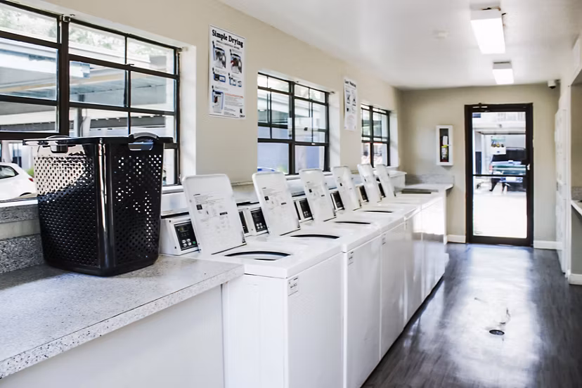 Modern laundry facility with high-efficiency machines at 3 Corners West Apartments