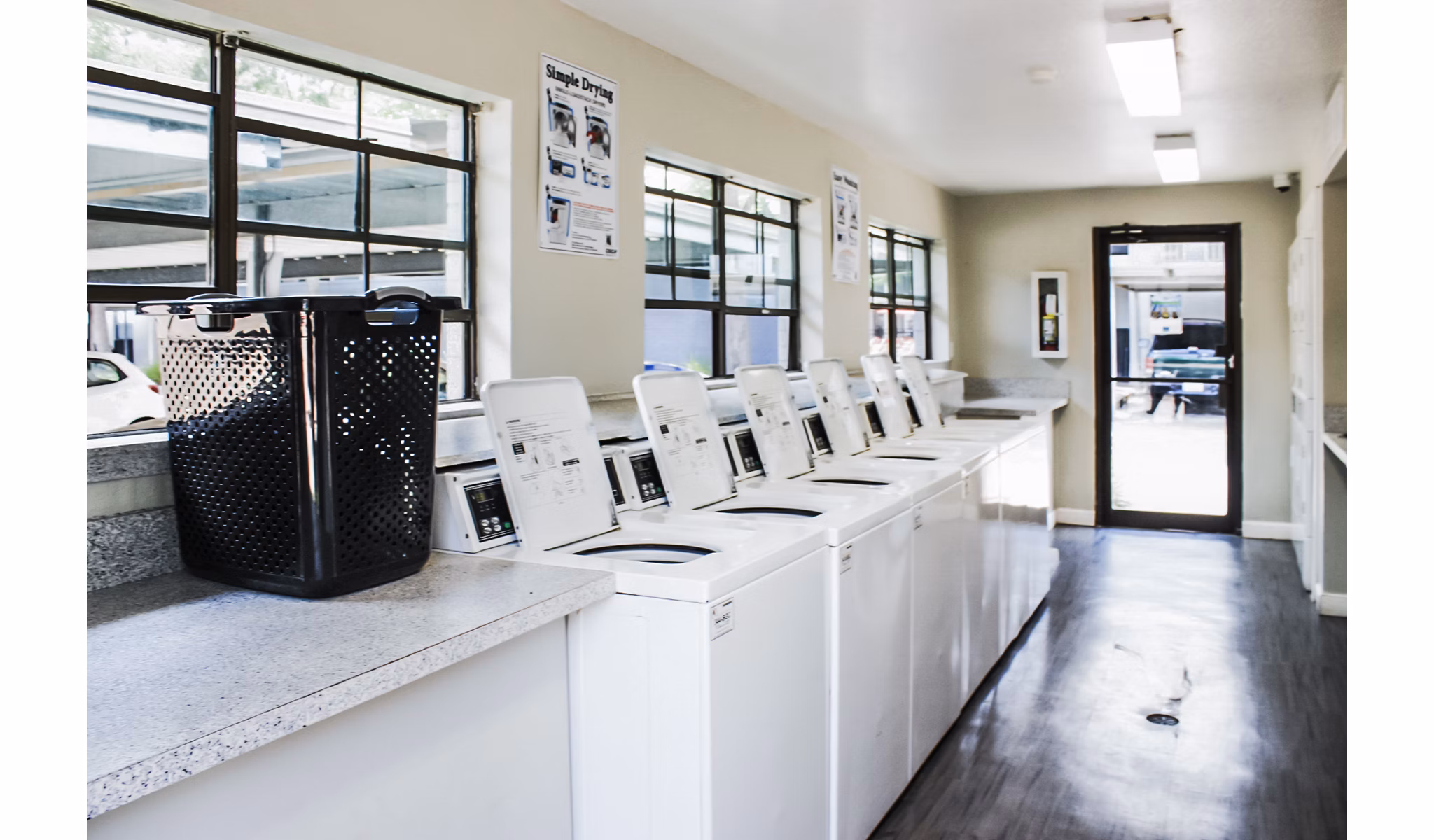 Modern laundry facility with high-efficiency machines at 3 Corners West Apartments