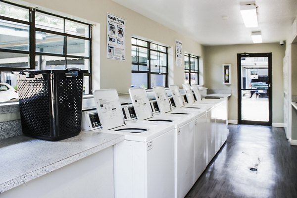 Modern laundry facility with high-efficiency machines at 3 Corners West Apartments