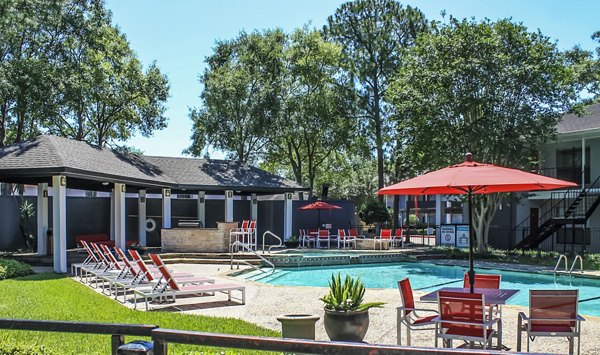 Pool with modern lounge chairs at 3 Corners West Apartments, a luxury residential community