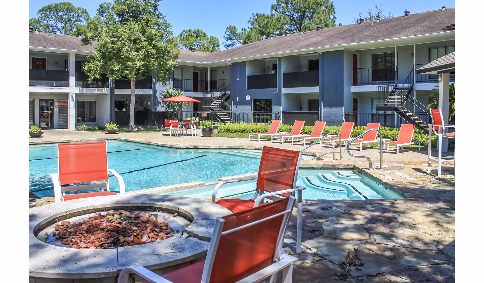 Outdoor pool with lounge chairs at 3 Corners West Apartments