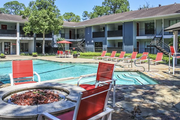 Outdoor pool with lounge chairs at 3 Corners West Apartments
