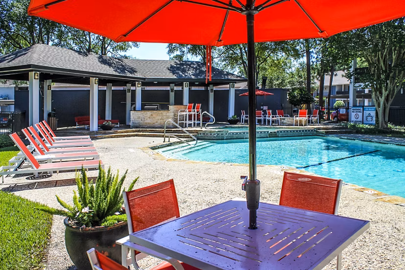 Refreshing pool with poolside loungers at 3 Corners West Apartments