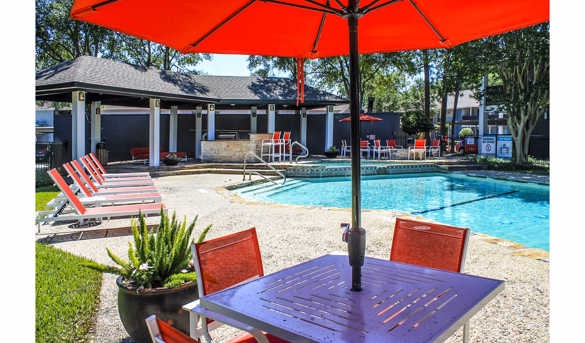 Refreshing pool with poolside loungers at 3 Corners West Apartments