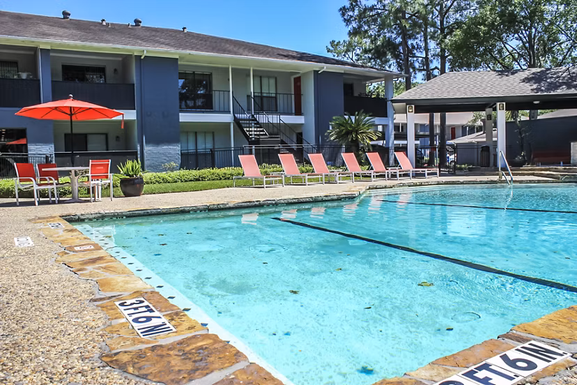 Sparkling outdoor pool at 3 Corners West Apartments, ideal for relaxation and sunbathing amidst luxury surroundings
