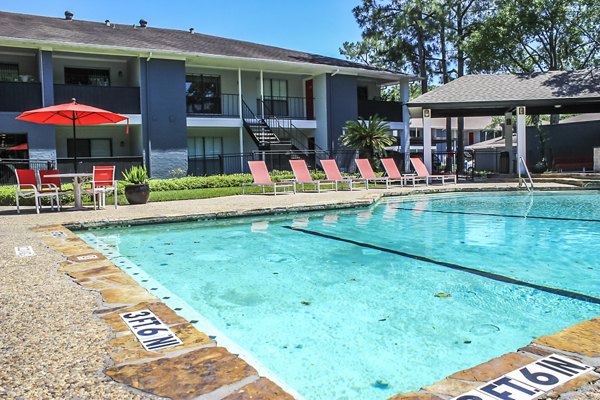 Sparkling outdoor pool at 3 Corners West Apartments, ideal for relaxation and sunbathing amidst luxury surroundings