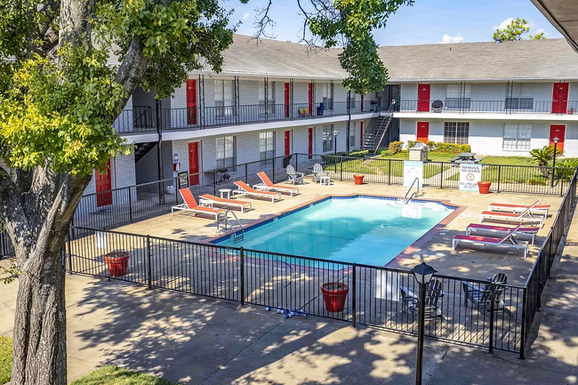 Resort-style pool with sun loungers at 3 Corners West Apartments