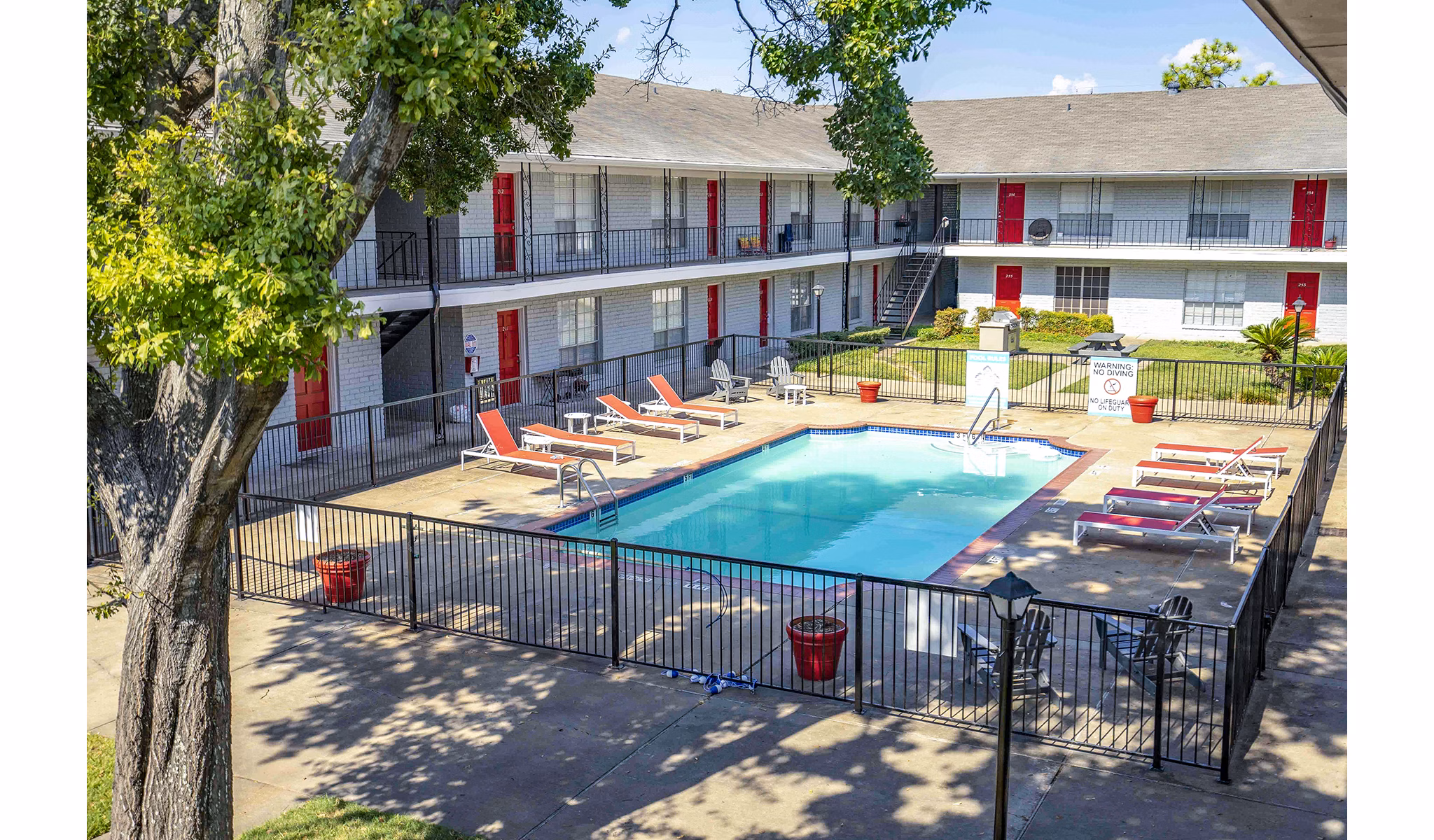 Resort-style pool with sun loungers at 3 Corners West Apartments