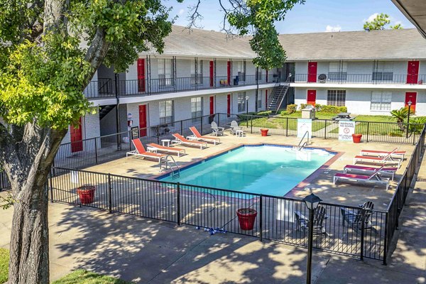 Resort-style pool with sun loungers at 3 Corners West Apartments