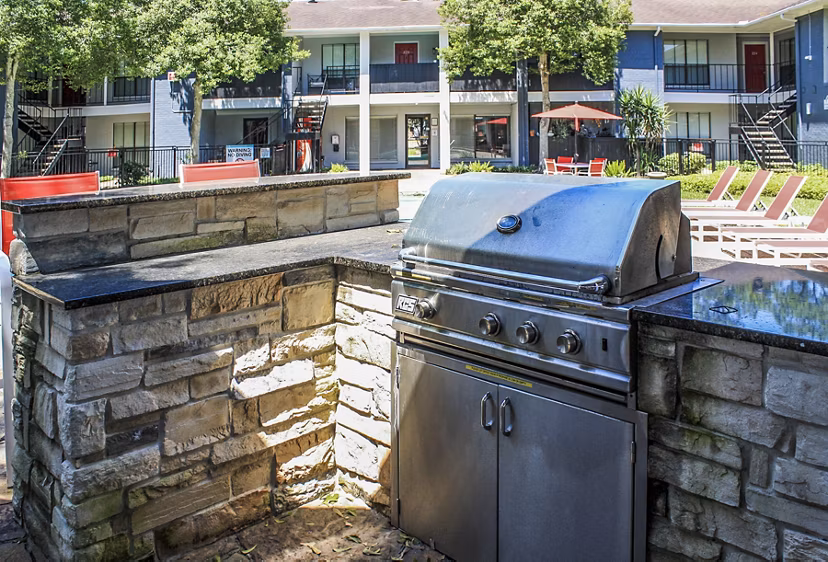Grill area at 3 Corners West Apartments: Outdoor cooking station with modern grills and seating for gatherings