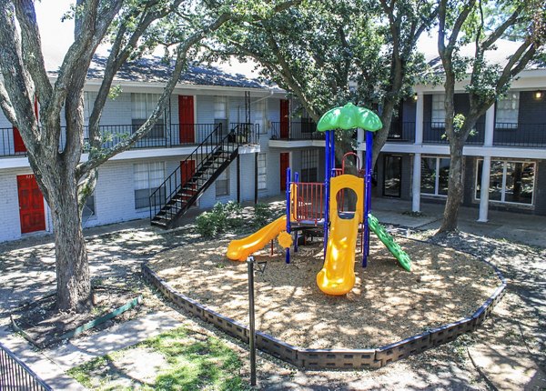 Modern playground at 3 Corners West Apartments with slides and climbing structures, ideal for families seeking active outdoor fun