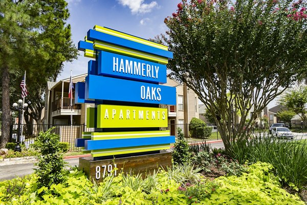 Signage displaying Hammerly Oaks Apartments logo at property entrance