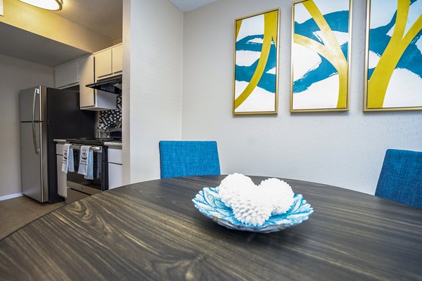 Dining room featuring modern decor and large windows at Hammerly Oaks Apartments