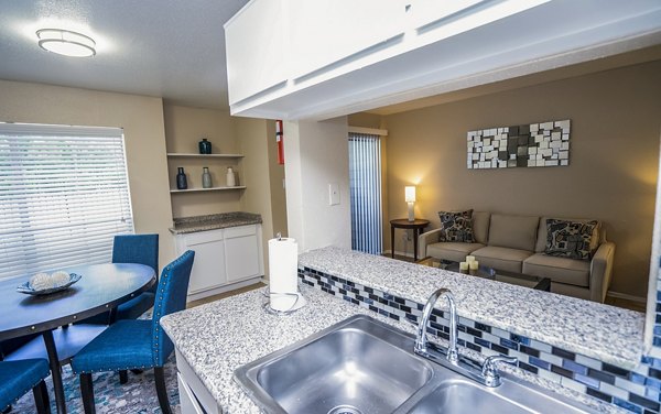 Contemporary kitchen with stainless steel appliances in Hammerly Oaks Apartments