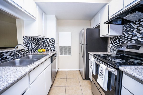 Kitchen featuring modern appliances and granite countertops at Hammerly Oaks Apartments
