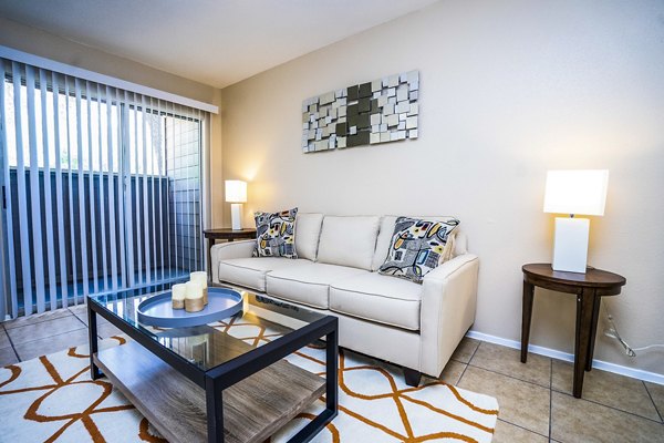 Living room with modern decor and natural lighting at Hammerly Oaks Apartments