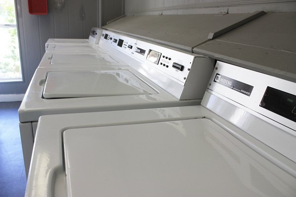 Convenient laundry facility at Hammerly Oaks Apartments with modern machines for tenant use