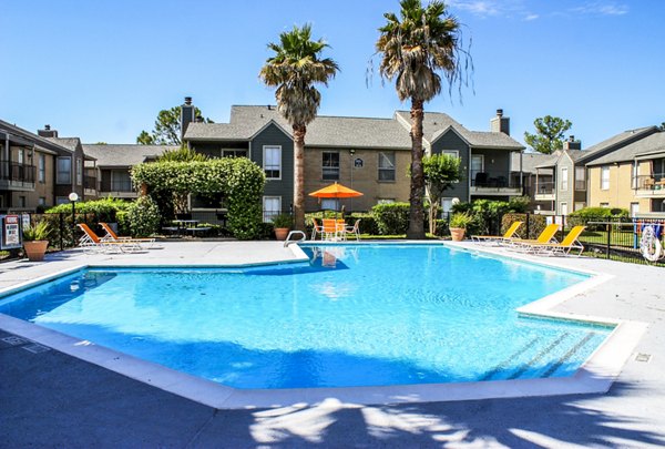Refreshing pool at Hammerly Oaks Apartments with poolside lounging areas