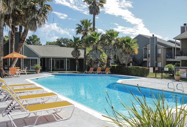 Luxurious pool area at Hammerly Oaks Apartments with lounge seating and greenery Ideal for relaxation and recreation in a vibrant community setting