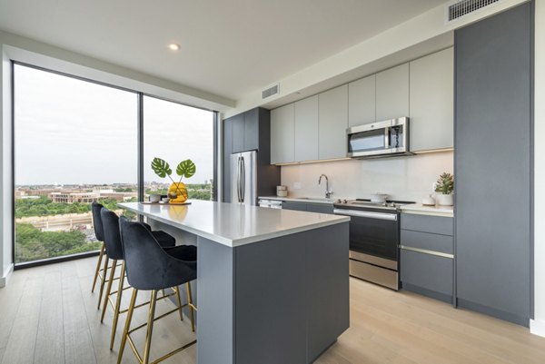 Modern kitchen with stainless steel appliances in Eastline Residences Apartments