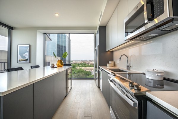 Modern kitchen with stainless steel appliances at Eastline Residences Apartments