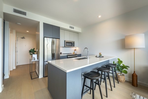 Modern kitchen with stainless steel appliances in Eastline Residences Apartments