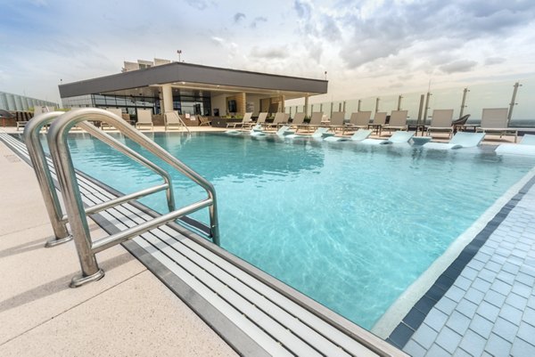 Luxurious pool with lounge chairs at Eastline Residences Apartments, ideal for relaxation and recreation in a serene atmosphere