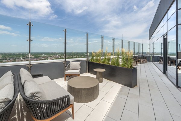 Scenic rooftop deck with seating and lush greenery at Eastline Residences Apartments