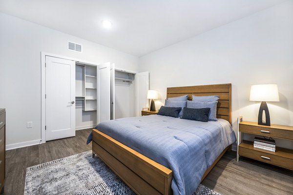 Comfortable bedroom with modern decor at Woodside Trumbull Apartments
