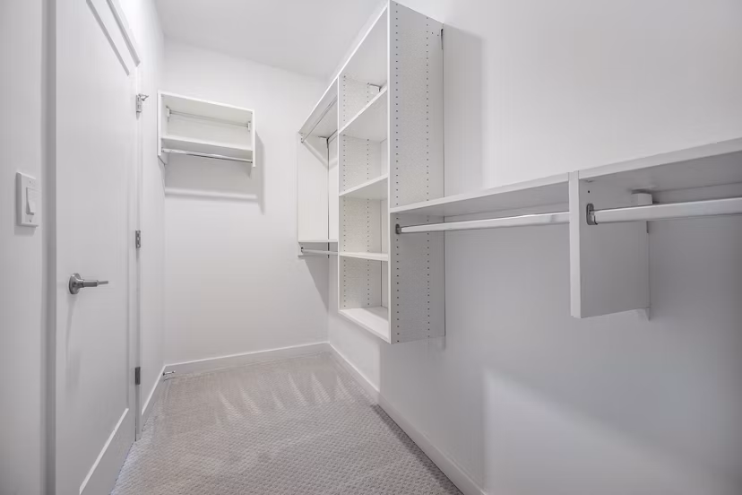 Spacious bedroom closet with ample storage space at Woodside Trumbull Apartments Perfect for organizing clothing and personal items