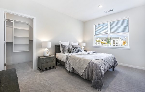 Bedroom featuring modern design elements at Woodside Trumbull Apartments