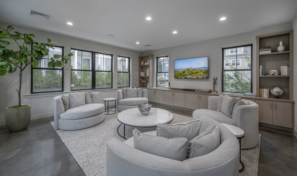 Clubhouse featuring modern design and cozy seating at Woodside Trumbull Apartments
