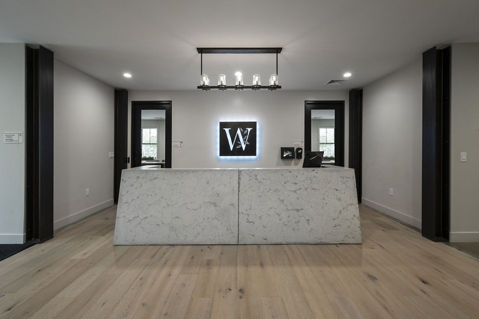 Clubhouse featuring modern design and seating areas at Woodside Trumbull Apartments, luxury property by Greystar