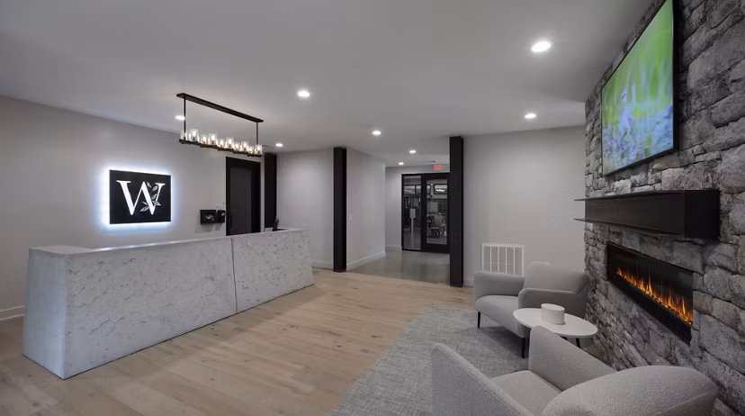 Clubhouse interior at Woodside Trumbull Apartments featuring modern furnishings and spacious design