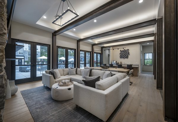 Clubhouse with modern design and cozy seating at Woodside Trumbull Apartments