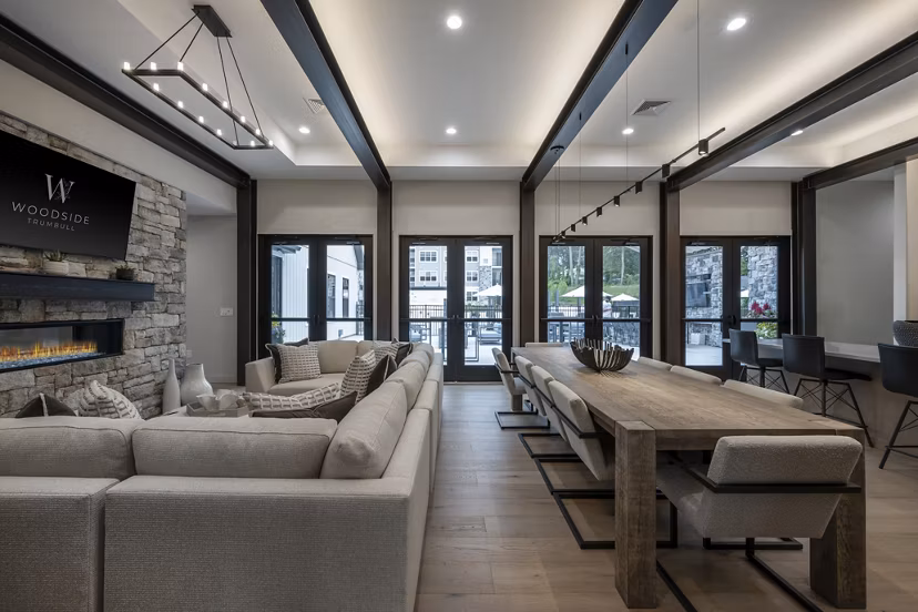 Clubhouse with modern design and cozy seating at Woodside Trumbull Apartments