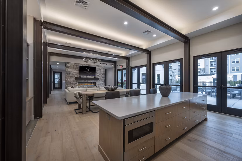 Clubhouse featuring modern furnishings and gathering spaces at Woodside Trumbull Apartments