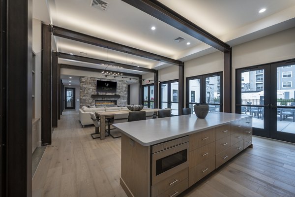 Clubhouse featuring modern furnishings and gathering spaces at Woodside Trumbull Apartments