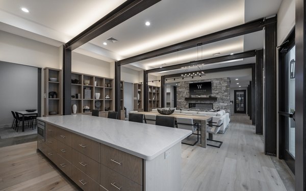 Clubhouse with modern furnishings and entertainment space at Woodside Trumbull Apartments