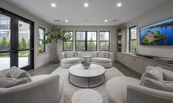Clubhouse featuring modern decor and seating at Woodside Trumbull Apartments