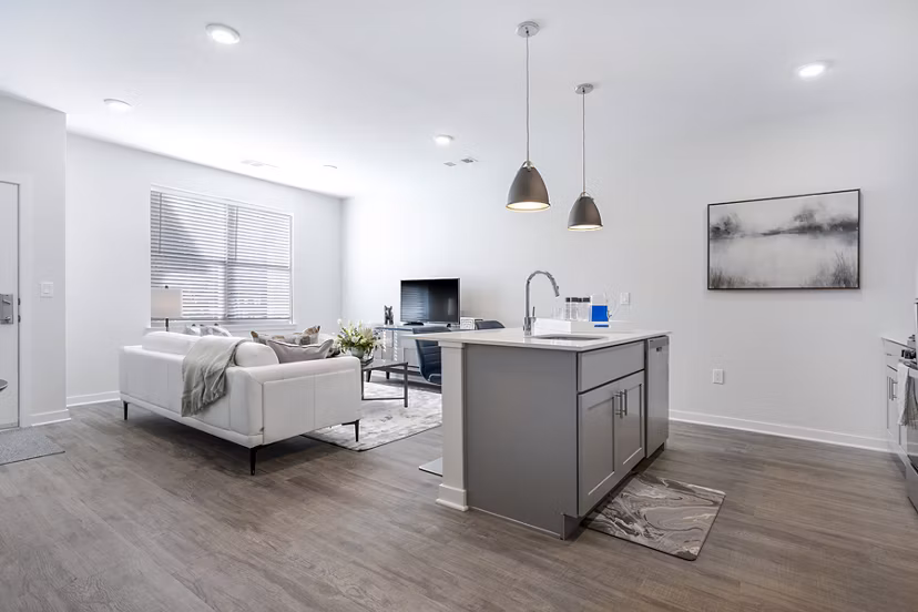 Modern kitchen with stainless steel appliances at Woodside Trumbull Apartments