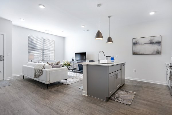 Modern kitchen with stainless steel appliances at Woodside Trumbull Apartments