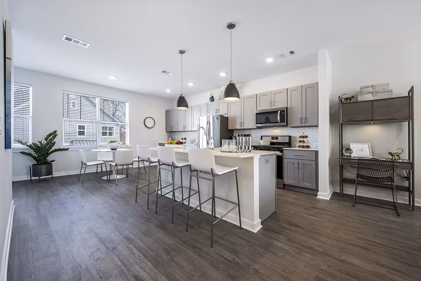 Modern kitchen with stainless steel appliances and granite countertops at Woodside Trumbull Apartments