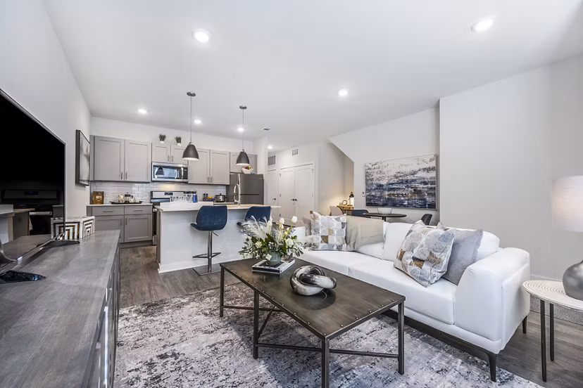 Cozy living room with modern furnishings at Woodside Trumbull Apartments