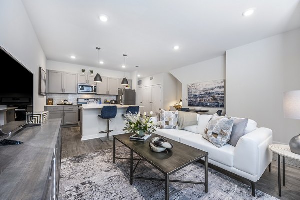 Cozy living room with modern furnishings at Woodside Trumbull Apartments