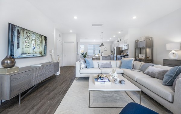 Living room with plush seating and modern decor at Woodside Trumbull Apartments