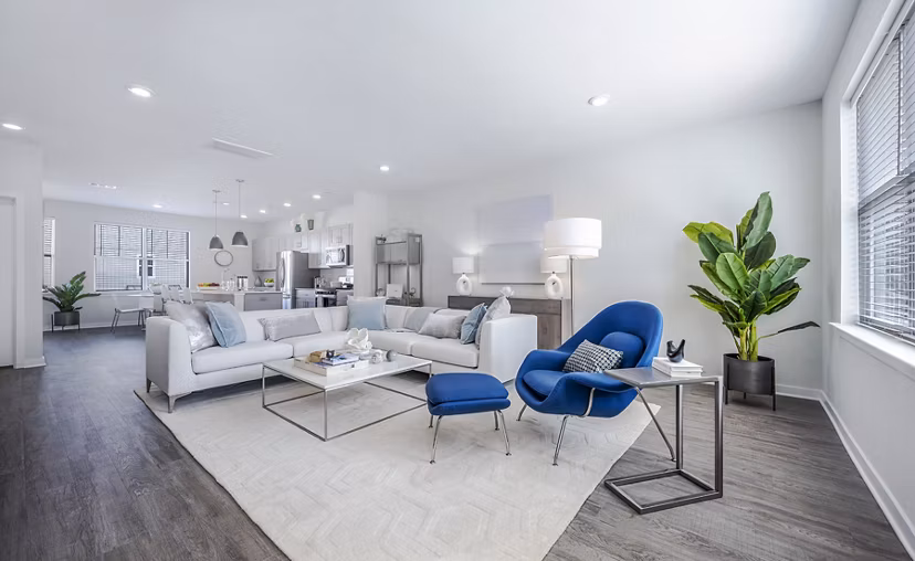 Cozy living room with plush seating and natural light at Woodside Trumbull Apartments