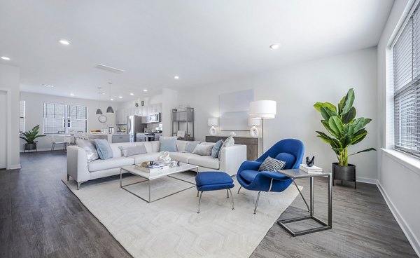 Cozy living room with plush seating and natural light at Woodside Trumbull Apartments