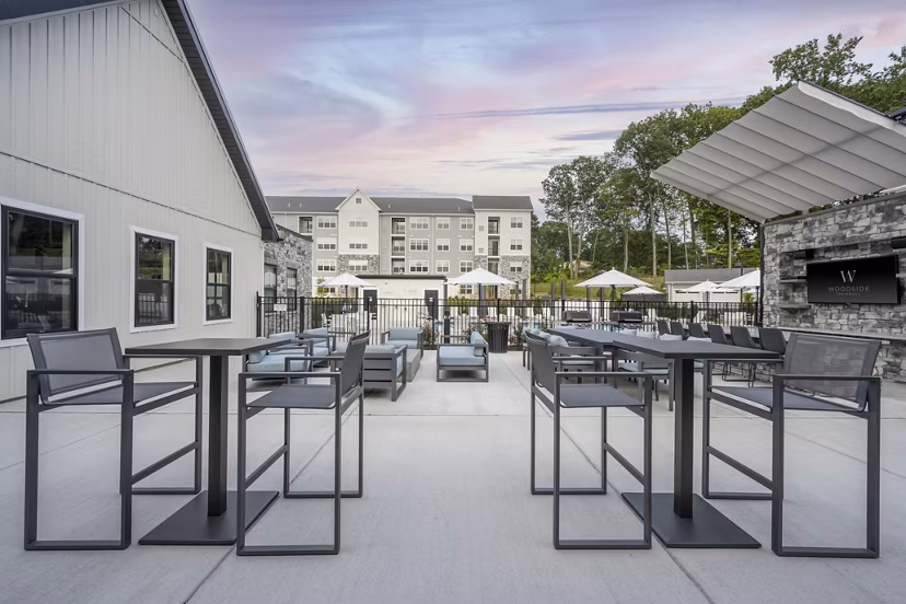 Courtyard featuring landscaped gardens and seating at Woodside Trumbull Apartments